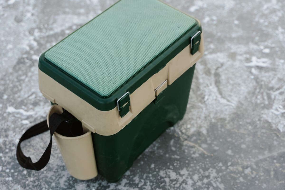Ducting running from a fog machine into a cooler on a patio