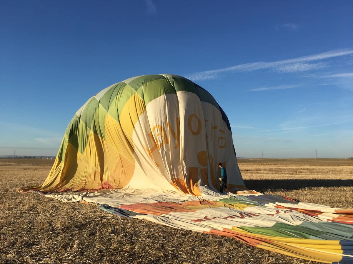 A partially deflated inflatable decoration slumped on a lawn