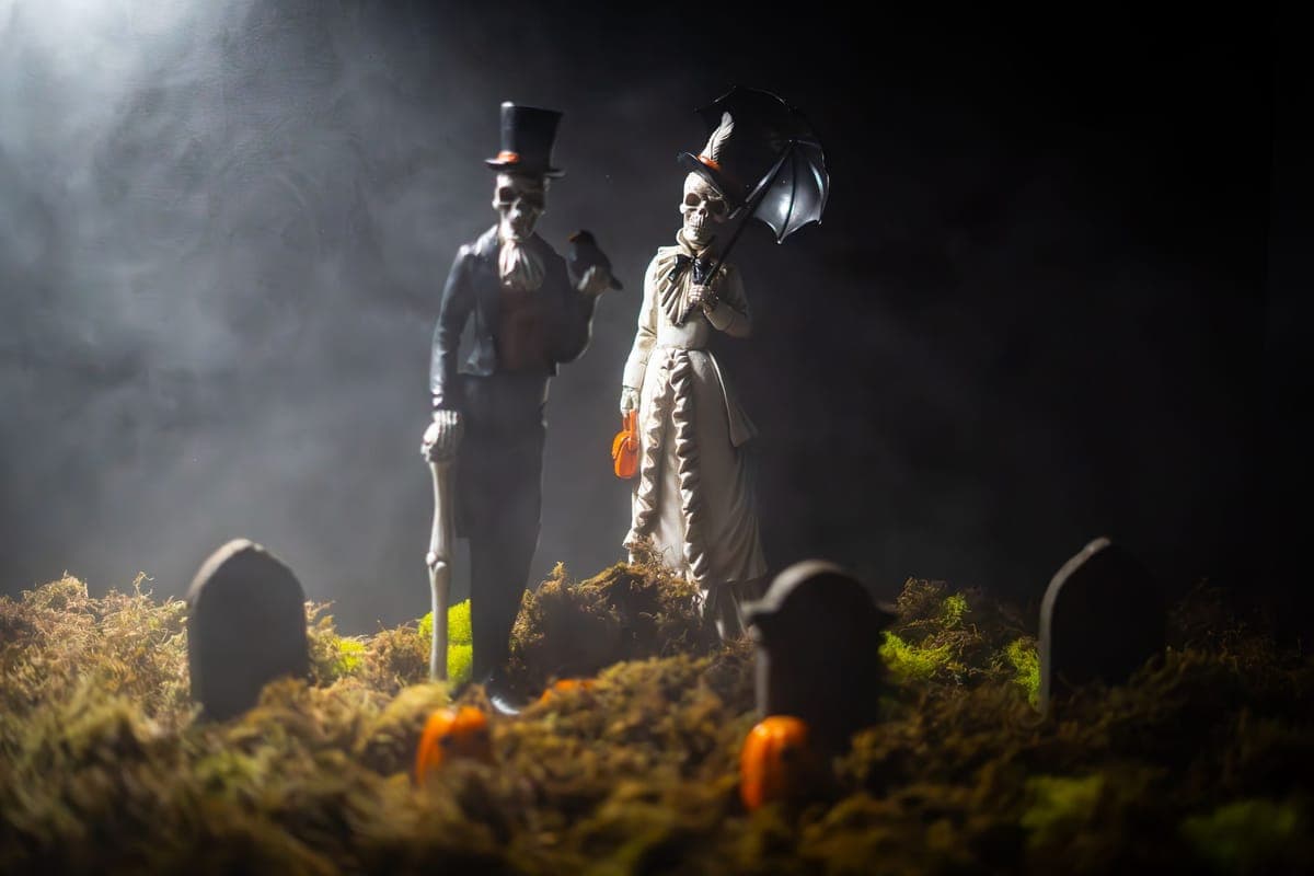 A themed graveyard scene lit in green across a front lawn