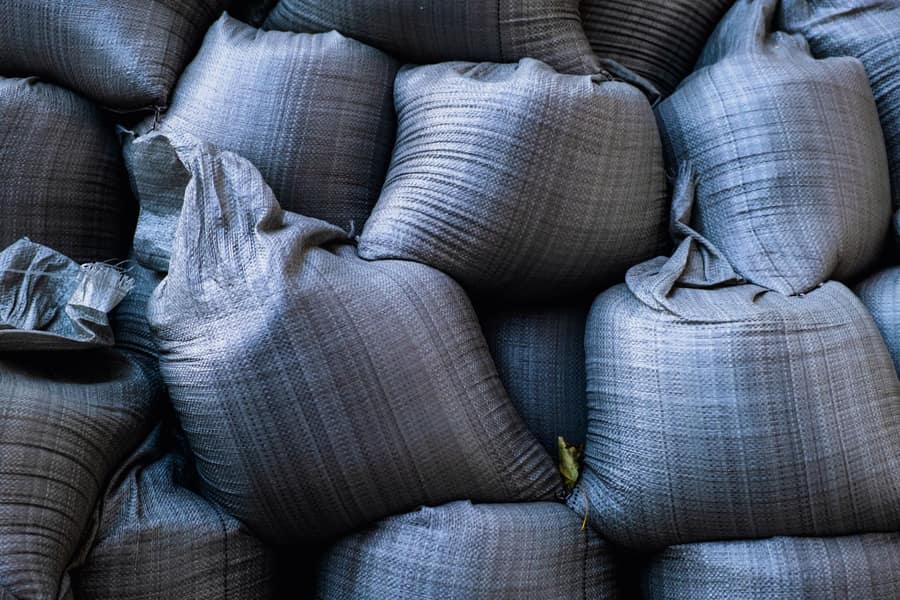 Weighted bags holding down the base of a display on a paved driveway