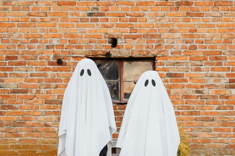 A white fabric ghost shape lit against a dark doorway