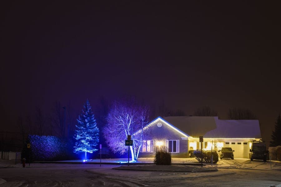 An inflatable yard decoration lit from within beside a driveway