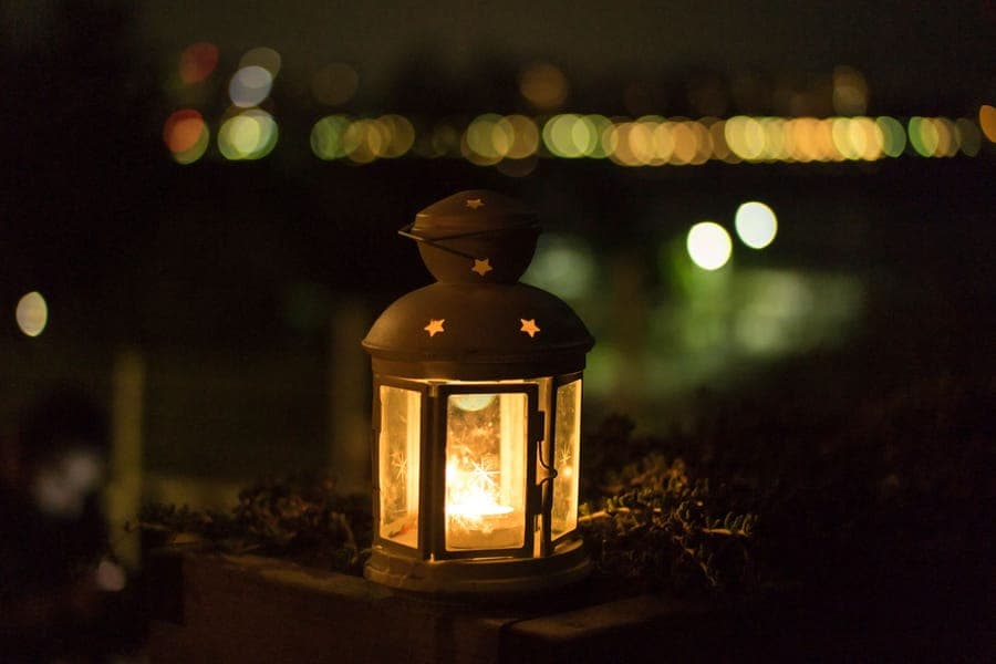 A lit yard prop standing in a bed well away from the house