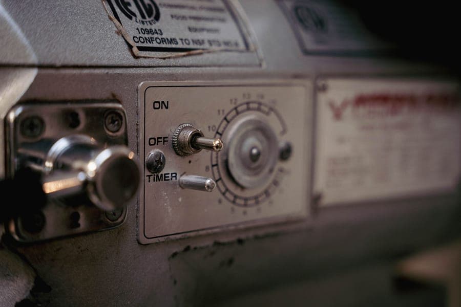 A dial timer in a weatherproof housing plugged into an outside socket