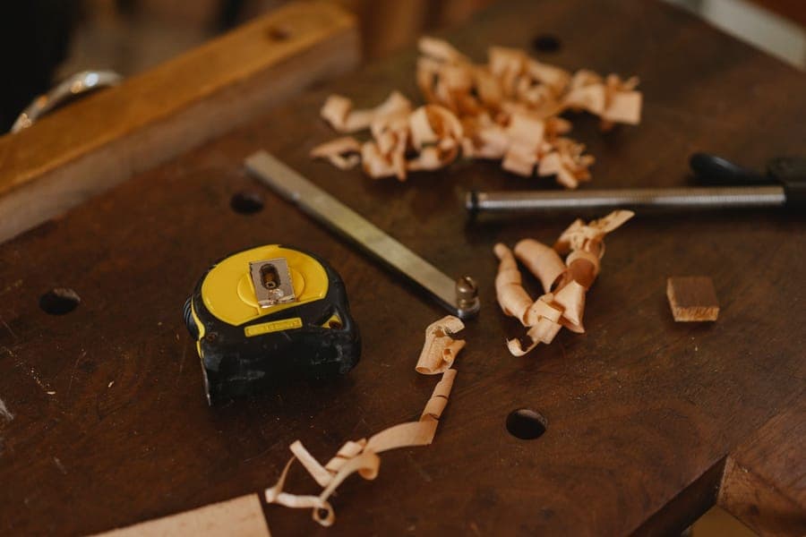 A patch kit and adhesive tape laid out on a workbench