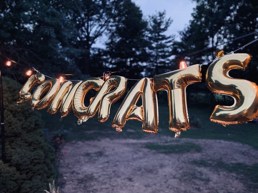 An oversized inflatable figure standing on a front lawn at twilight