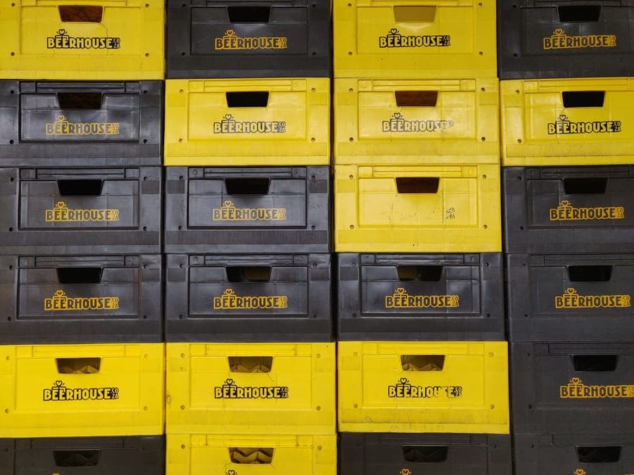 Stacked plastic storage totes on a garage shelf