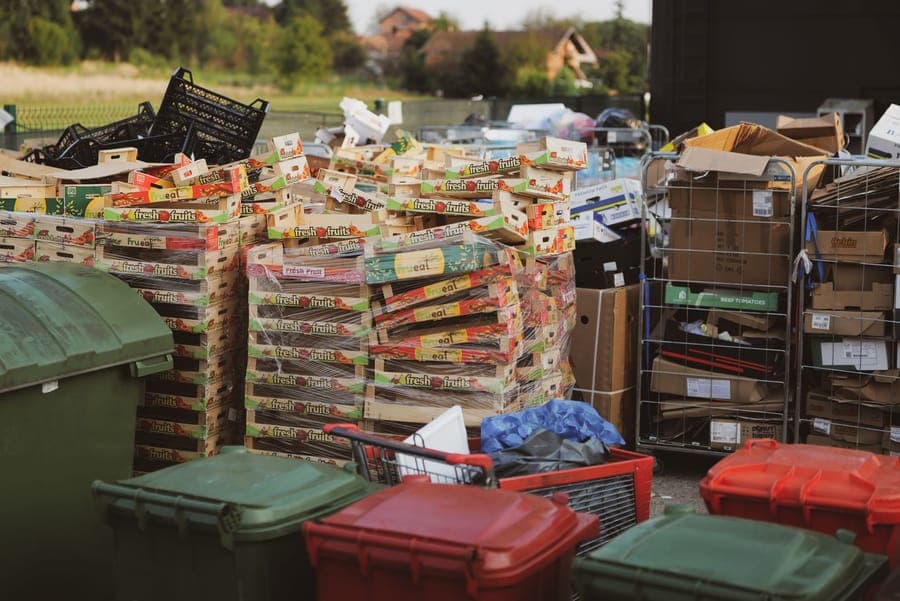 A large lidded bin open on a garage floor with folded fabric inside