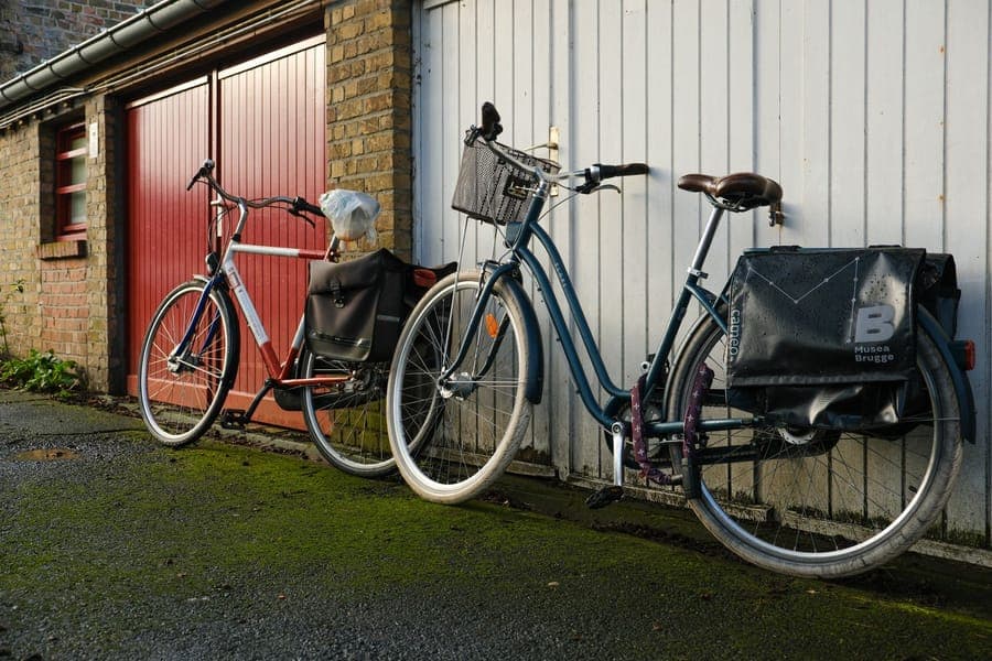 A long zippered storage bag leaning against a garage wall